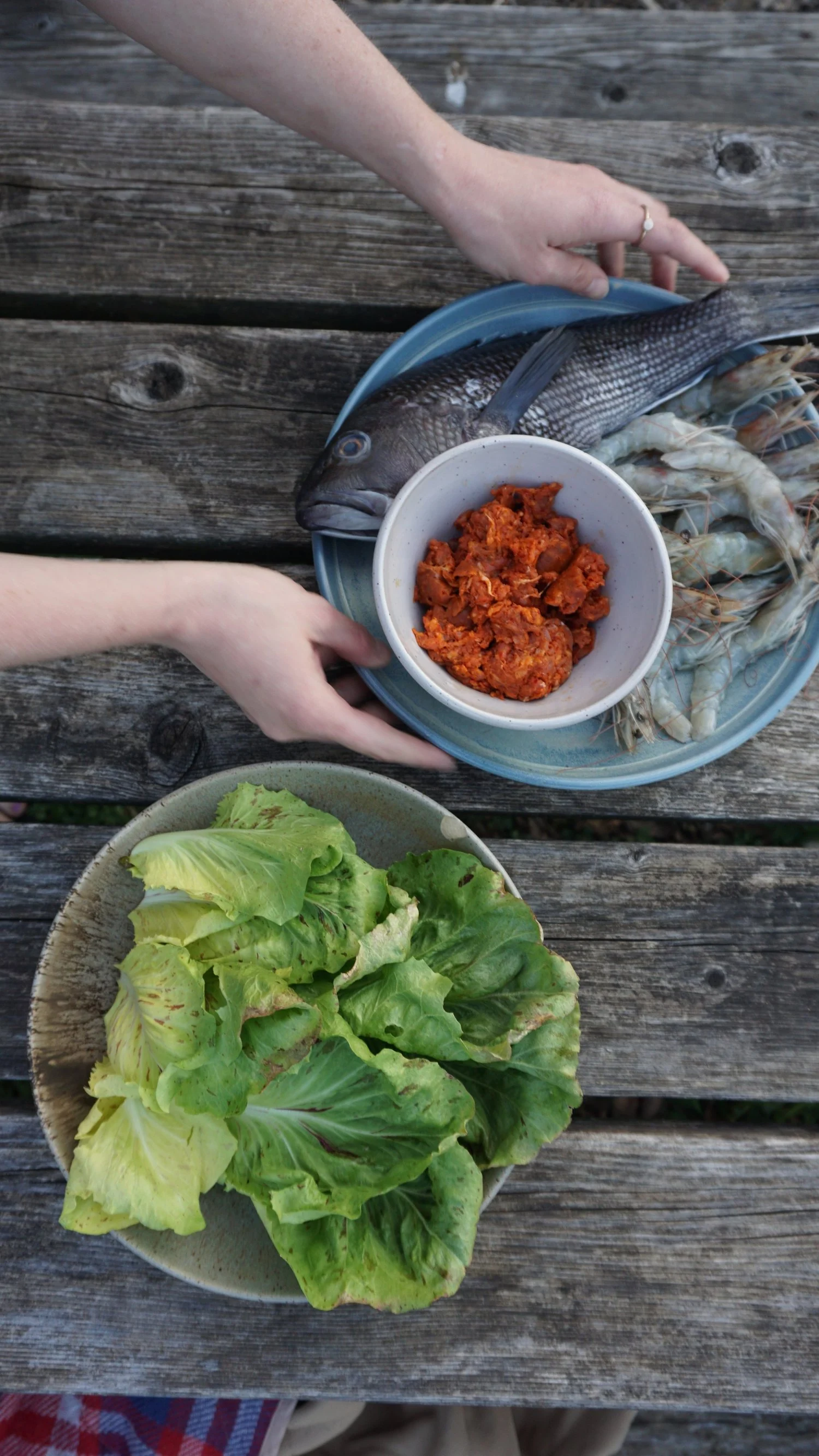 Fresh ingredients being arranged by hand for a private dinner